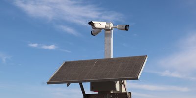A street-mounted ALPR camera scanning passing vehicles, representing an ALPR camera search and lookup system