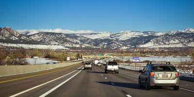 Colorado license plate on a vehicle parked with Rocky Mountain scenery, illustrating a Colorado license plate lookup