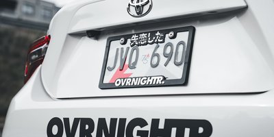 Close-up of a personalized vanity plate reading CURSOR on the back of a parked car