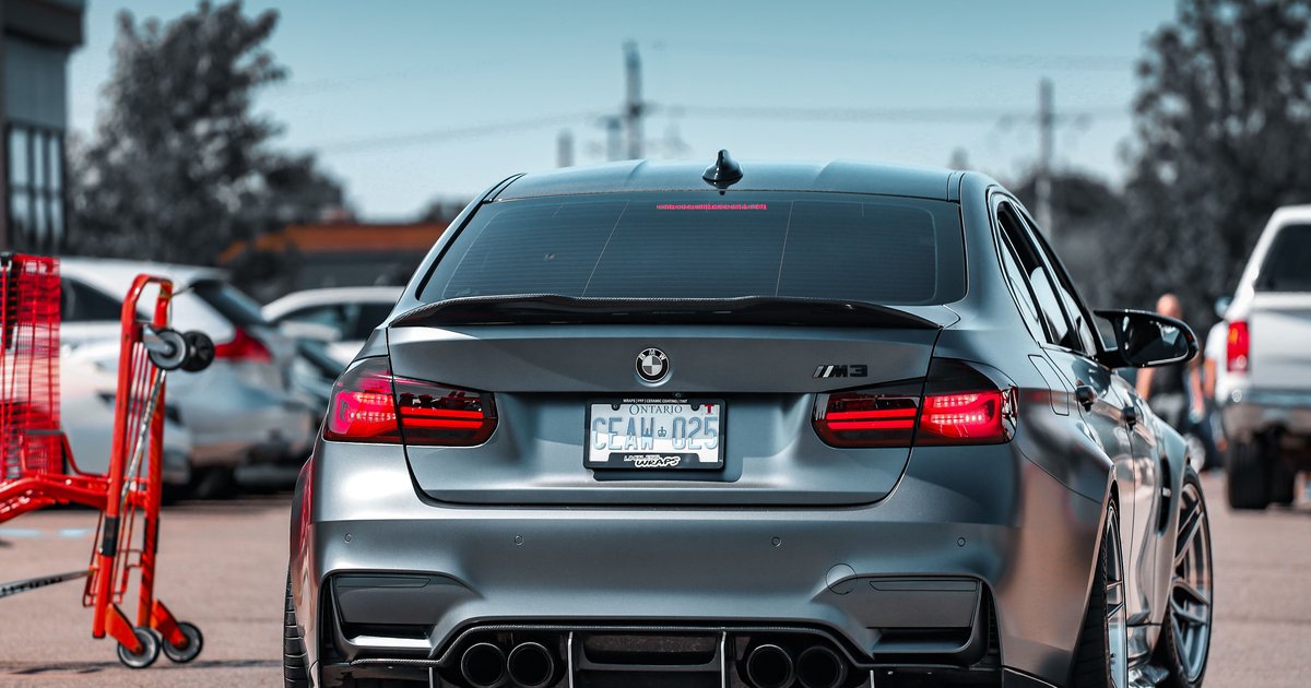 Close-up of a custom license plate on a car's rear bumper showing personalized vanity plate characters