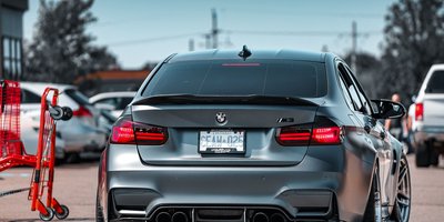 Close-up of a custom license plate on a car's rear bumper showing personalized vanity plate characters