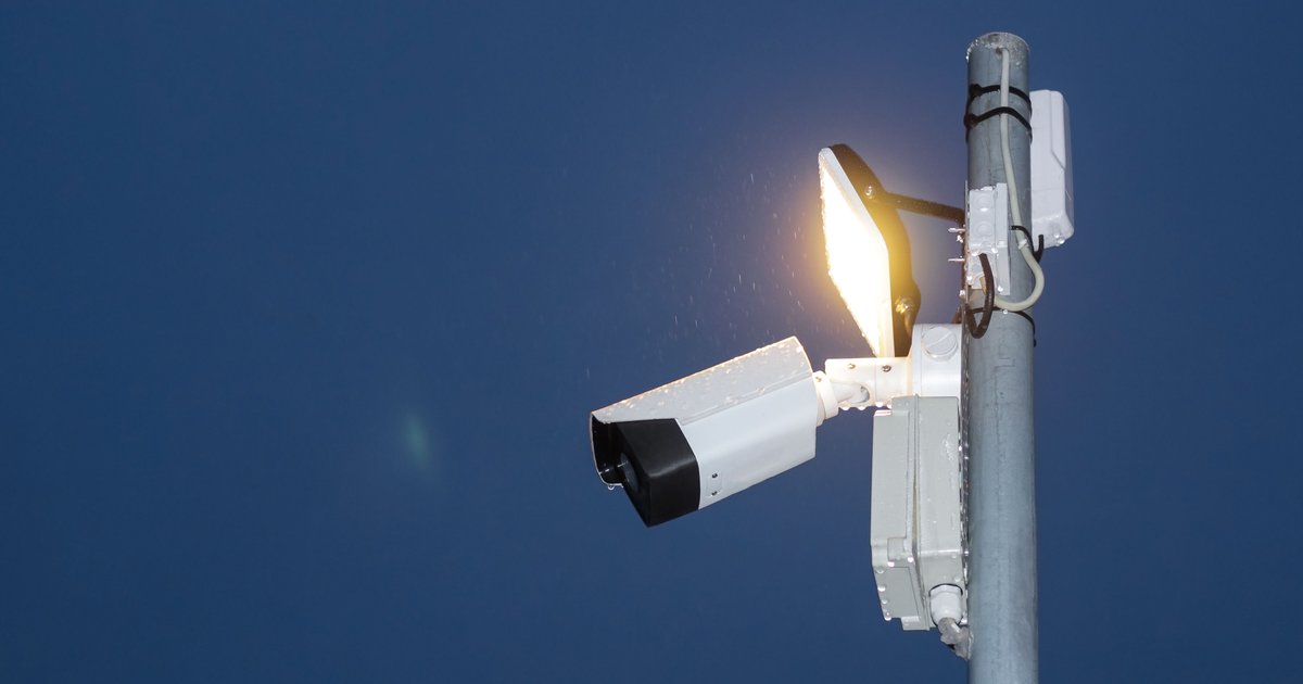 Flock Safety ALPR camera mounted on a roadside pole, representing a flock camera search engine lookup.