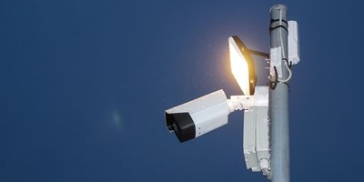 Flock Safety ALPR camera mounted on a roadside pole, representing a flock camera search engine lookup.