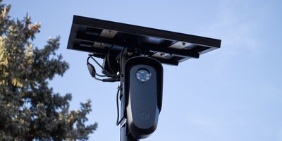 Automated license plate reader camera mounted on a pole, representing the Flock license plate database lookup topic.
