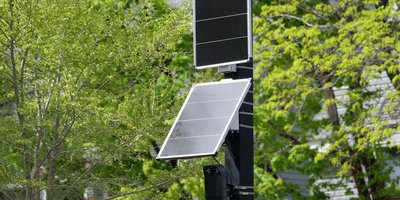 A Flock Safety automated license plate reader camera mounted on a roadside pole at the center of a privacy lawsuit.