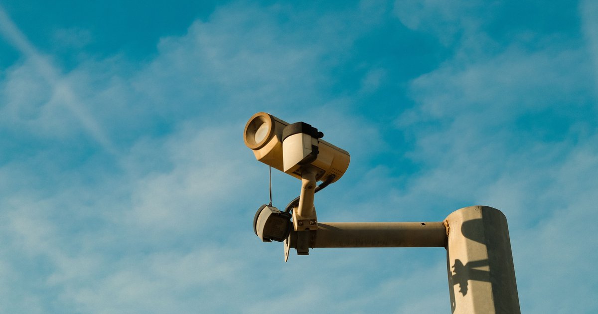 A Flock Safety ALPR camera mounted on a roadside pole, central to the flock safety lawsuit debate over mass surveillance