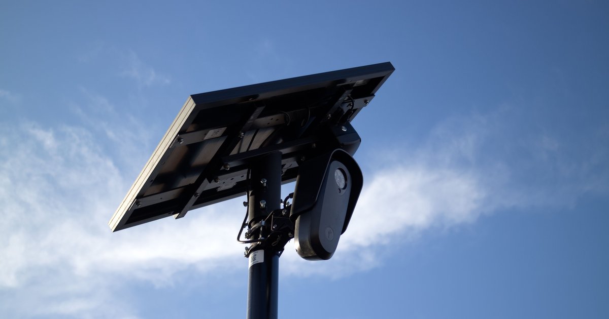 Automated license plate reader camera on a pole scanning traffic, illustrating haveibeenflocked surveillance concerns