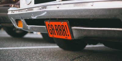 Close-up of a Missouri license plate mounted on a car bumper illustrating license plate laws in Missouri