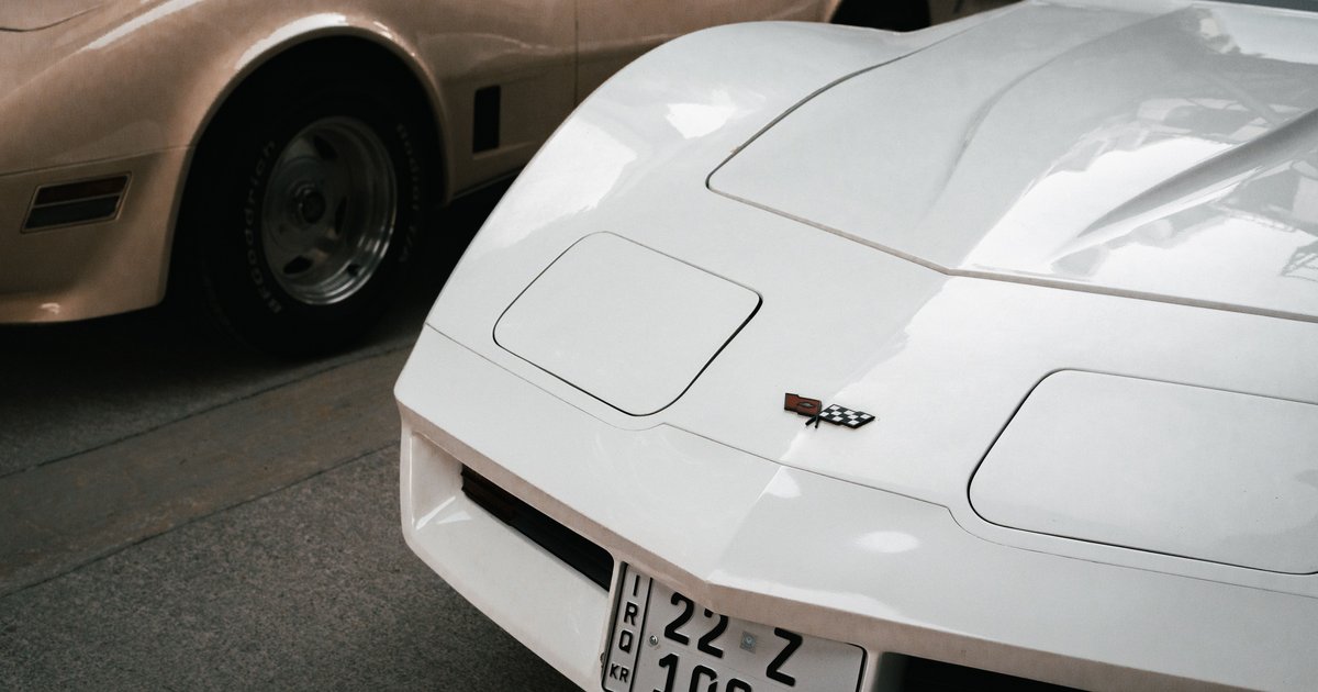 Close-up of a car's rear license plate being photographed for a license plate lookup search