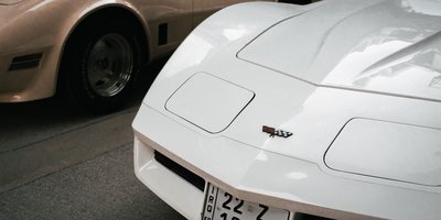 Close-up of a car's rear license plate being photographed for a license plate lookup search