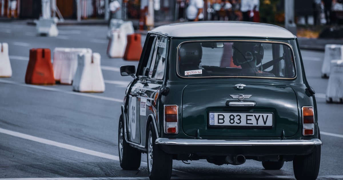Close-up of a NIFTY vanity plate mounted on the back of a small classic car