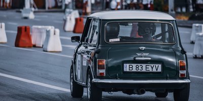 Close-up of a NIFTY vanity plate mounted on the back of a small classic car