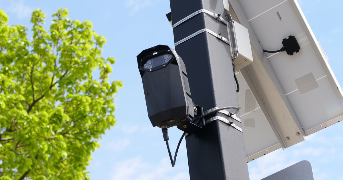 Automated license plate reader camera scanning a car, illustrating PlateQuery ALPR lookup history for free plate scan checks