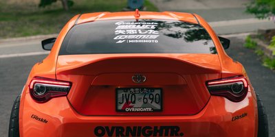 Close-up of a car's POSTER vanity plate illustrating the poster meaning behind personalized license plates