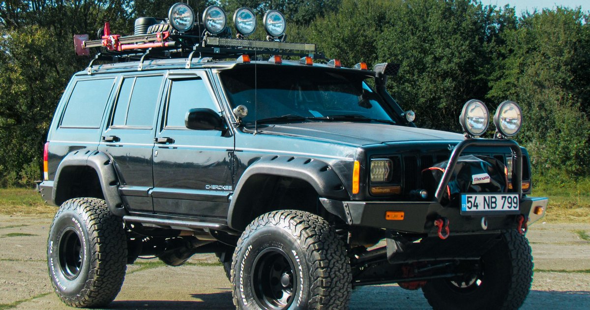 Close-up of a personalized TROLL vanity plate mounted on a lifted off-road vehicle bumper
